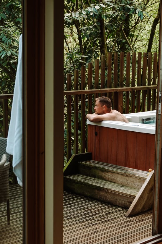 Man relaxing in the hot tub at Deerpark, Forest Holidays