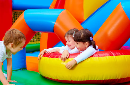 Kids playing on a bouncy castle