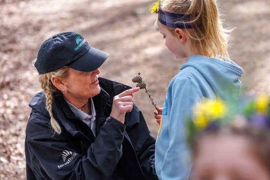 A child with a Forest Ranger at Forest Holidays