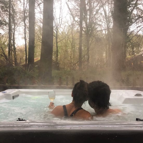 Couple sat in the hot tub at Forest Holidays