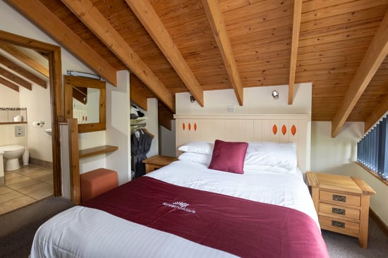 Golden Oak Treehouse master bedroom at Deerpark, Cornwall