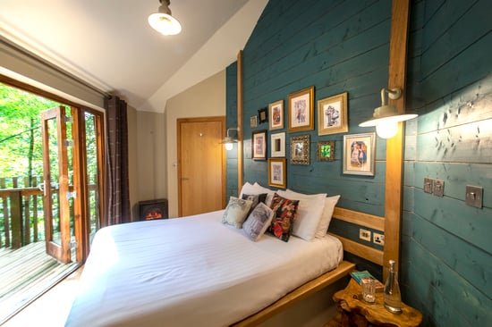 The Golden Oak Treehouse cabin bedroom area at Forest of Dean, Forest Holidays