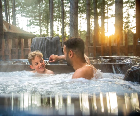 Son and father enjoying the hot tub at Forest Holidays