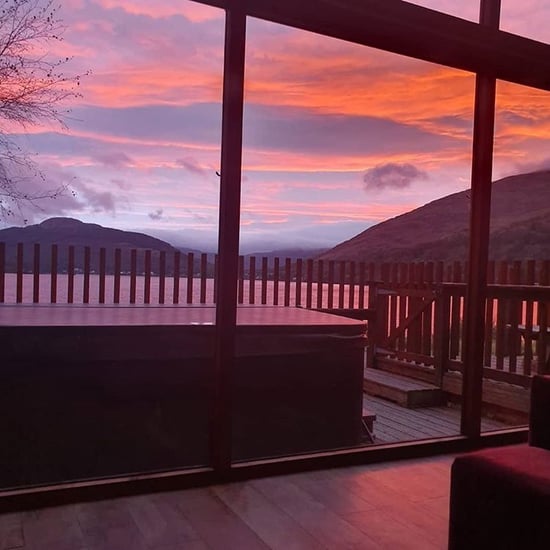 Log cabin at sunset in Ardgartan Argyll by Laura Dean