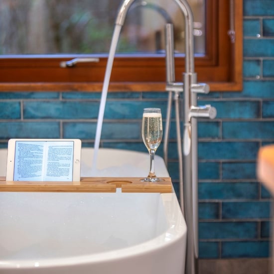 Bath tub and glass of prosecco inside the Golden Oak Hideaway at Delamere Forest
