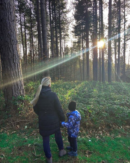 Mother and son walking in the forest