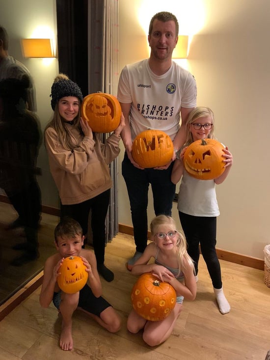 Guests holding their pumpkins at Forest Holidays