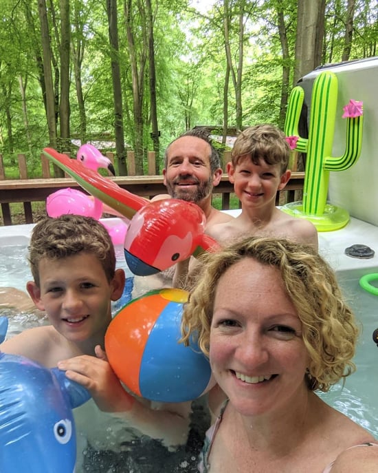 Family playing in the hot tub