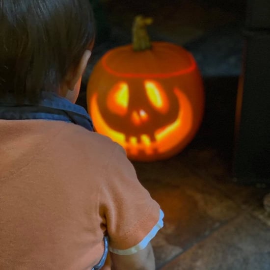 Child sat in front of a pumpkin