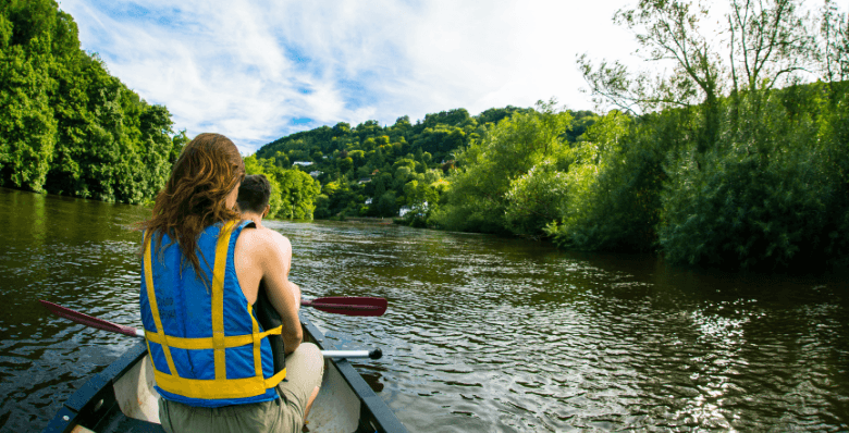 Couple canoeing down the River Wye at Forest of Dean
