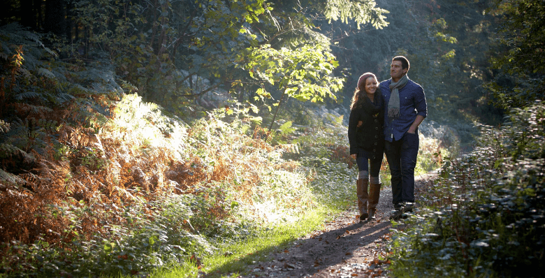 Couple walking through the forest