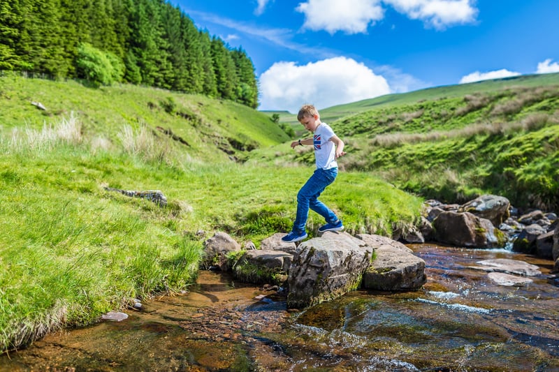 child playing in the brecon beacons, south wales 