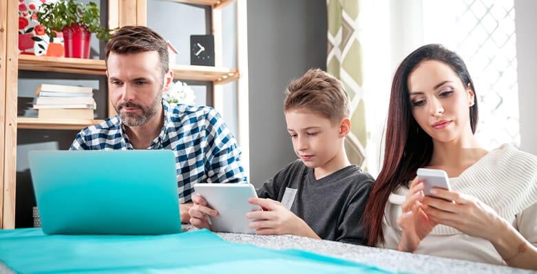 Family using electronic devices indoors