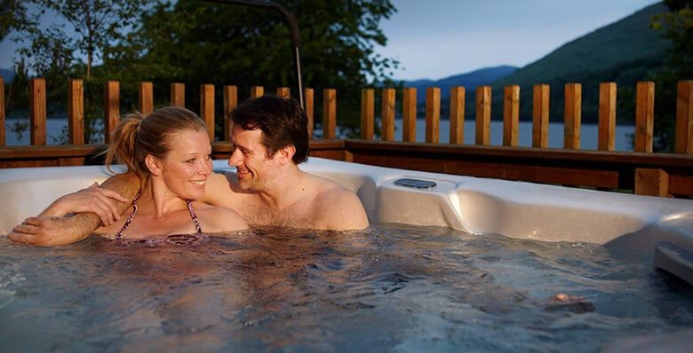 A couple relax in their hot tub