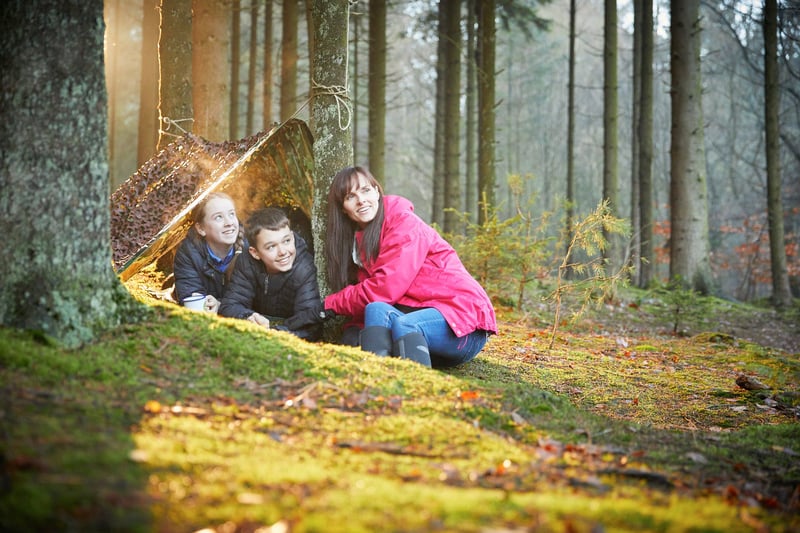 Guests at Forest Holidays making a den in the forest