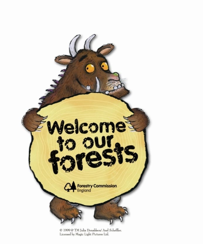 Gruffalo holding welcome to the forest sign