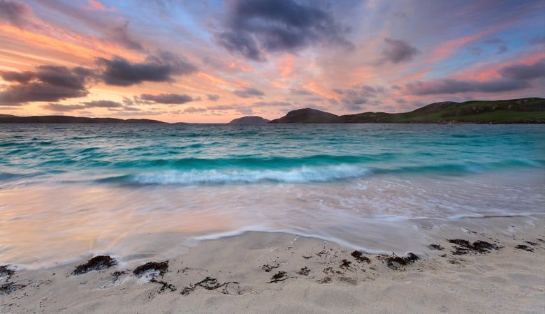 Sunrise over blue waters at Vatersay Beach