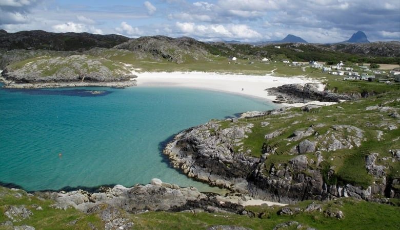 Blue waters and green coastline at Achmelvich beach