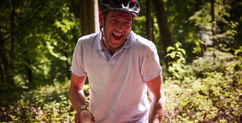 Man wearing bike helmet in the forest