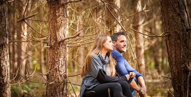Couple relaxing in the woodland