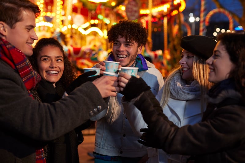 Group of friends enjoying a hot drink at the Christmas Markets