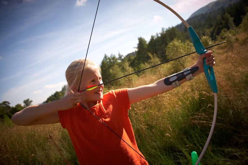 A girl trying out archery on a archery holiday at Forest Holidays
