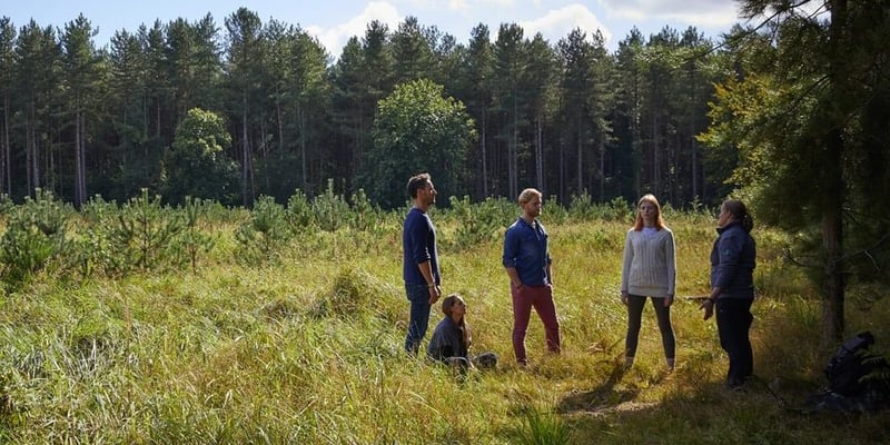 A group experiencing a Forest Bathing session led by a Forest Holidays Forest Ranger