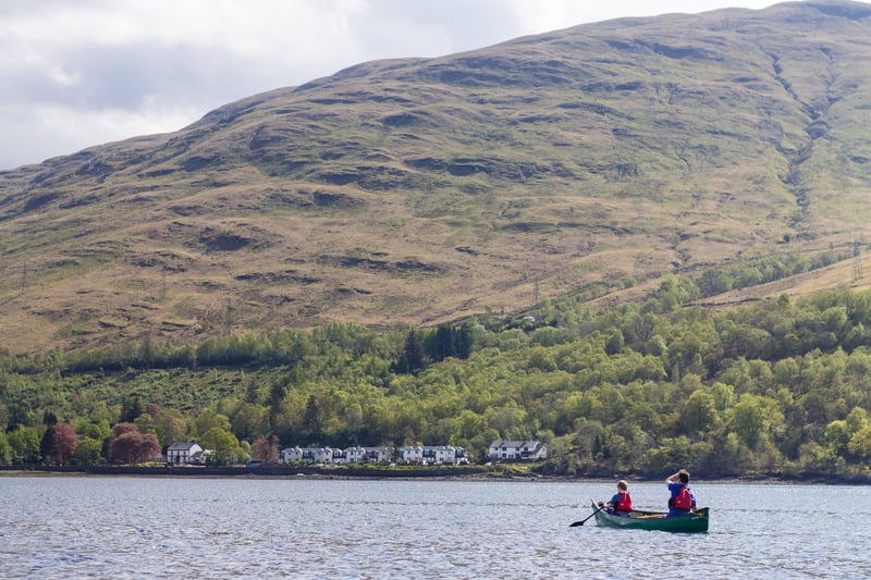A father and son canoeing together on Loch Long, Ardgartan Argyll, Scotland